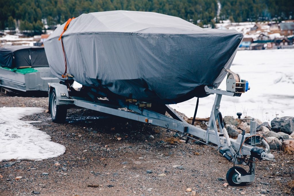 Covered boat on a pontoon trailer