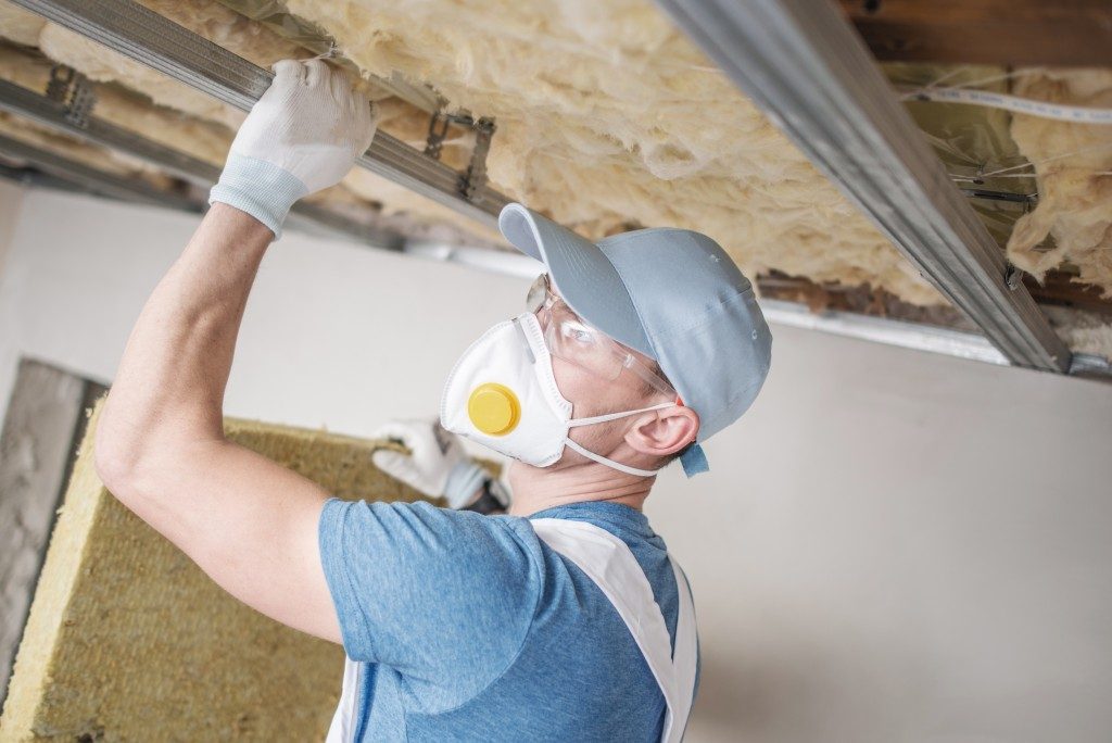 worker fixing home insulation