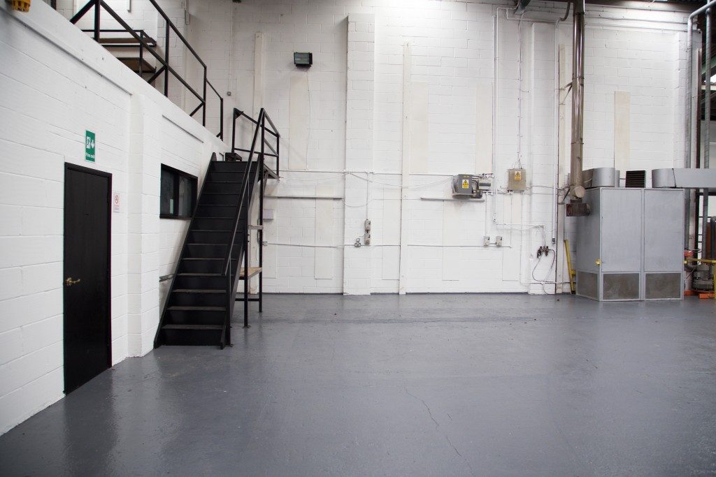 Stairs to mezzanine floor in vast empty warehouse
