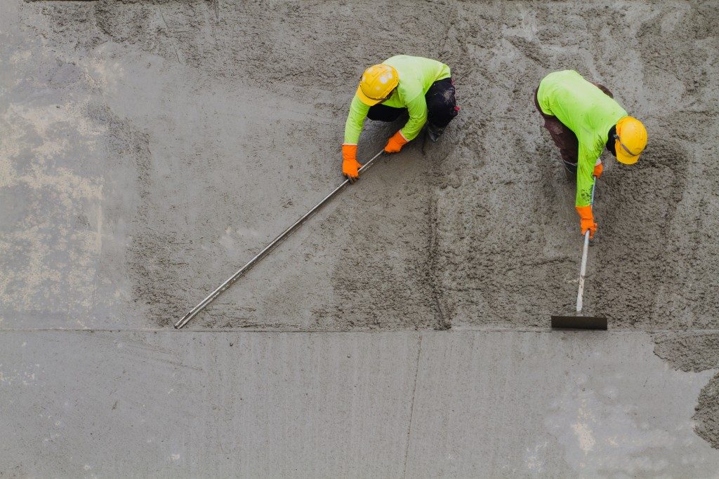 workers sealing the installed concrete
