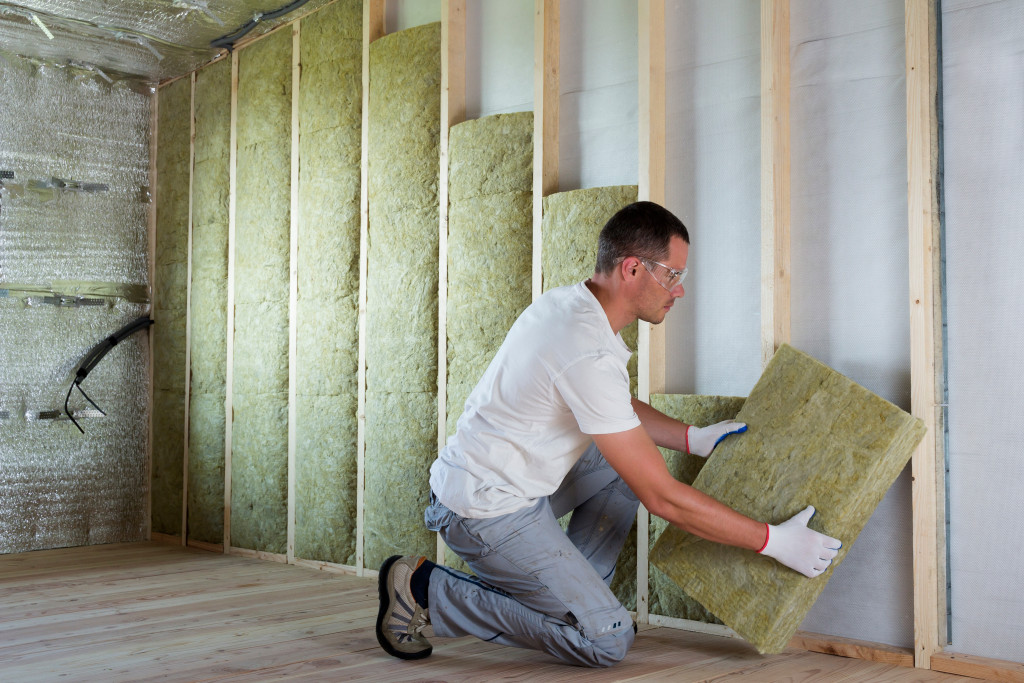 A Man Working on Insulation at Home