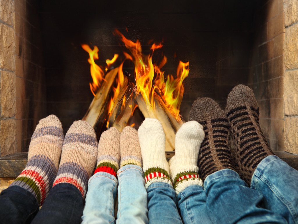 Family and their socks in front of fireplace