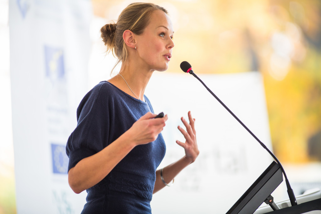 A woman giving a presentation in a seminar