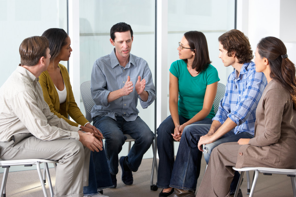 A man talking to a support group