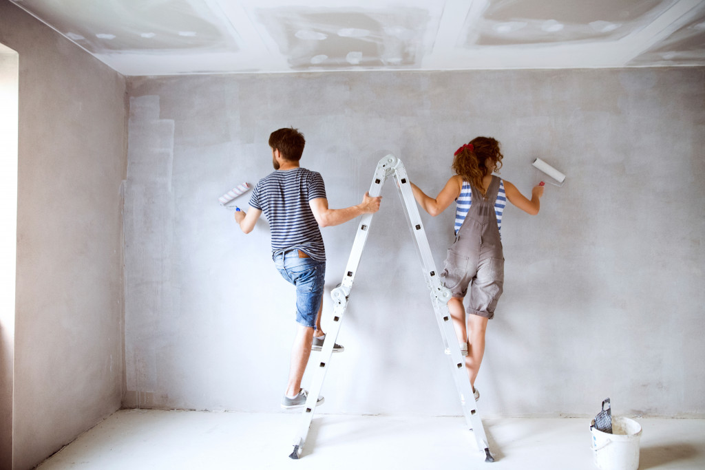 couple repainting a wall