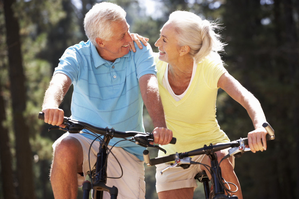 senior adults riding a bicycle