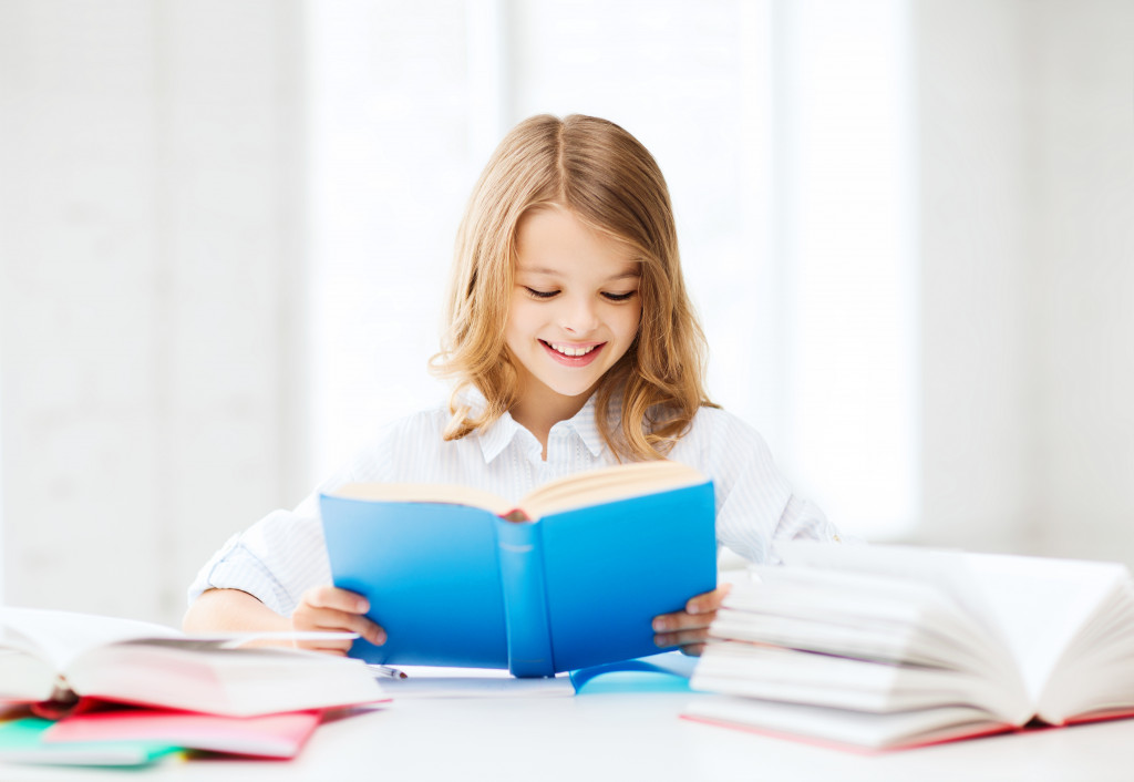 smiling child reading a book