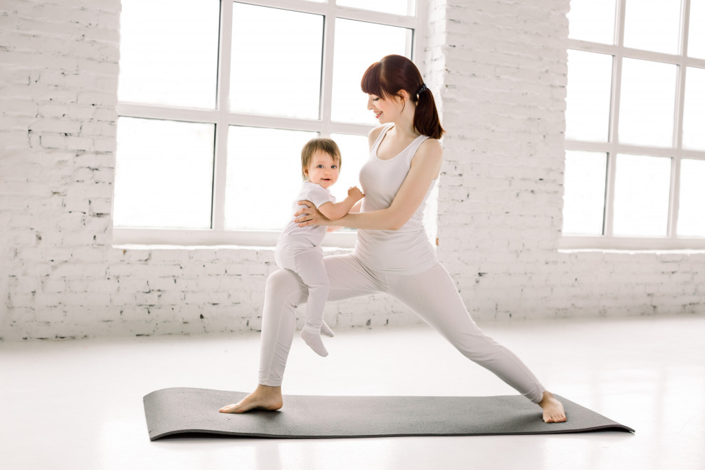 mom exercising with little one
