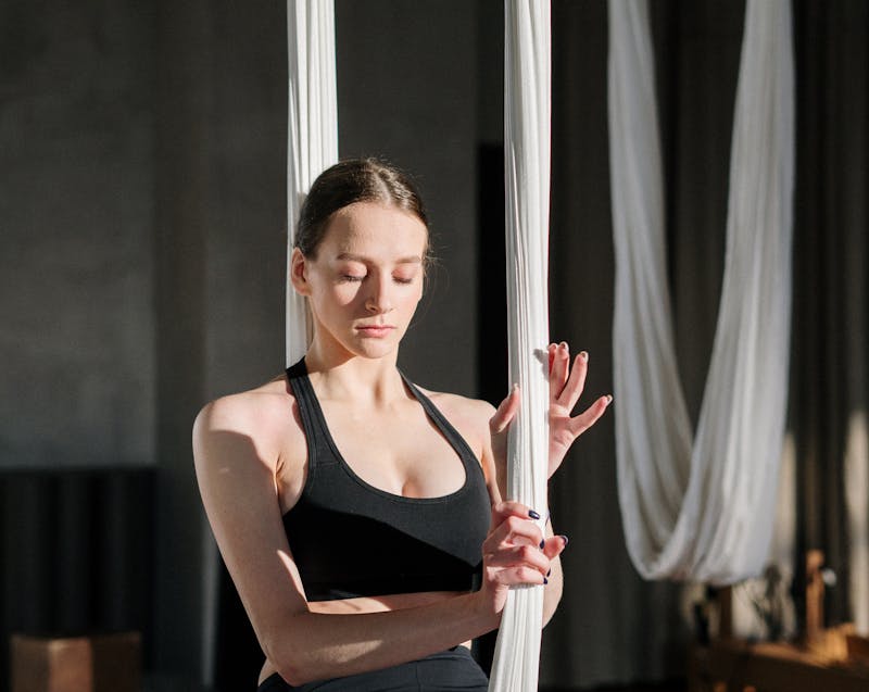 a woman doing aerial yoga
